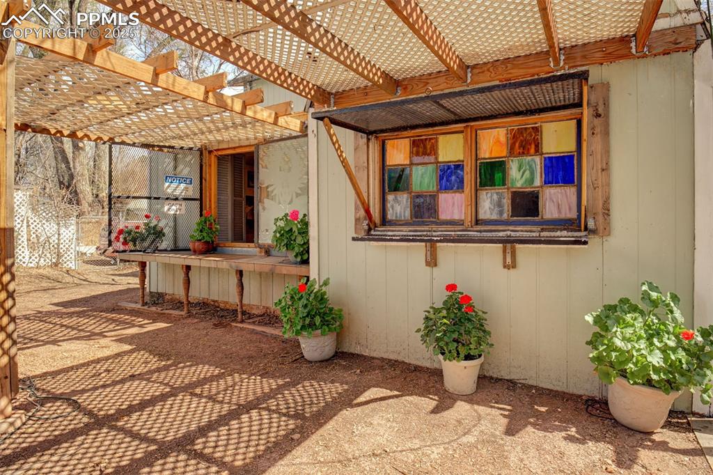 Image 20 of 45: Secret Garden: Bar Hut -One stained glass window, one sand blasted with bea