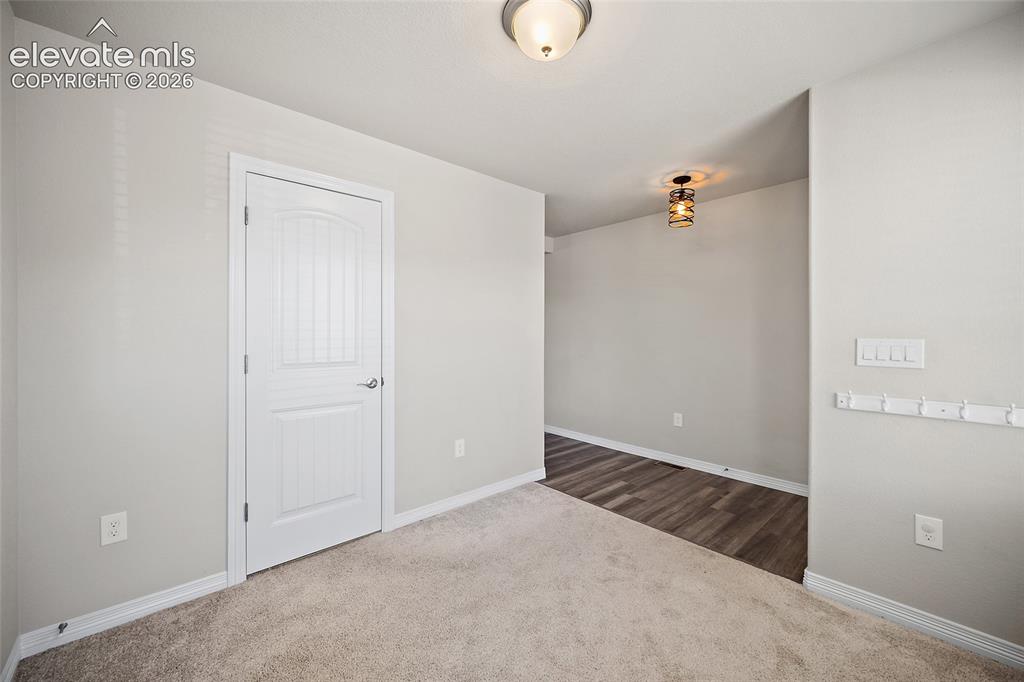 Image 15 of 49: Plank wood-finish flooring, neutral wall tones, and overhead lighting fixtu