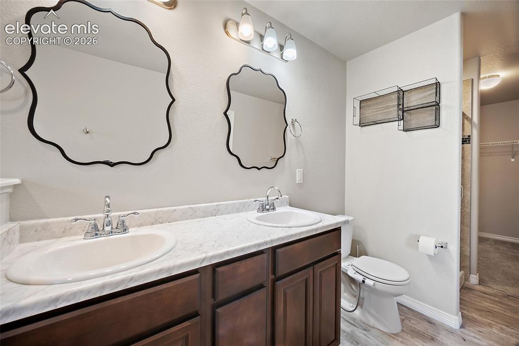 Image 21 of 49: Dual vanity with undermount sinks and chrome fixtures