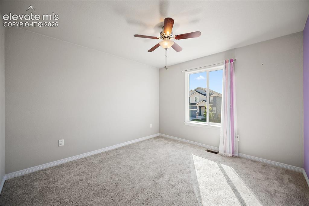 Image 29 of 49: Carpeted room featuring a ceiling fan with integrated lighting, a single wi