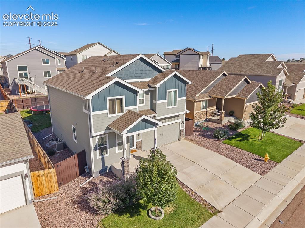 Image 3 of 49: Two-story residence featuring a combination of siding and shingle accents, 