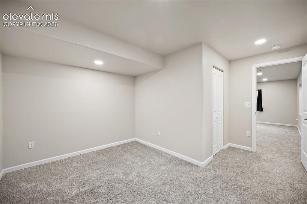 Image 33 of 49: Recessed lighting, light gray carpet flooring, neutral paint, white trim, a