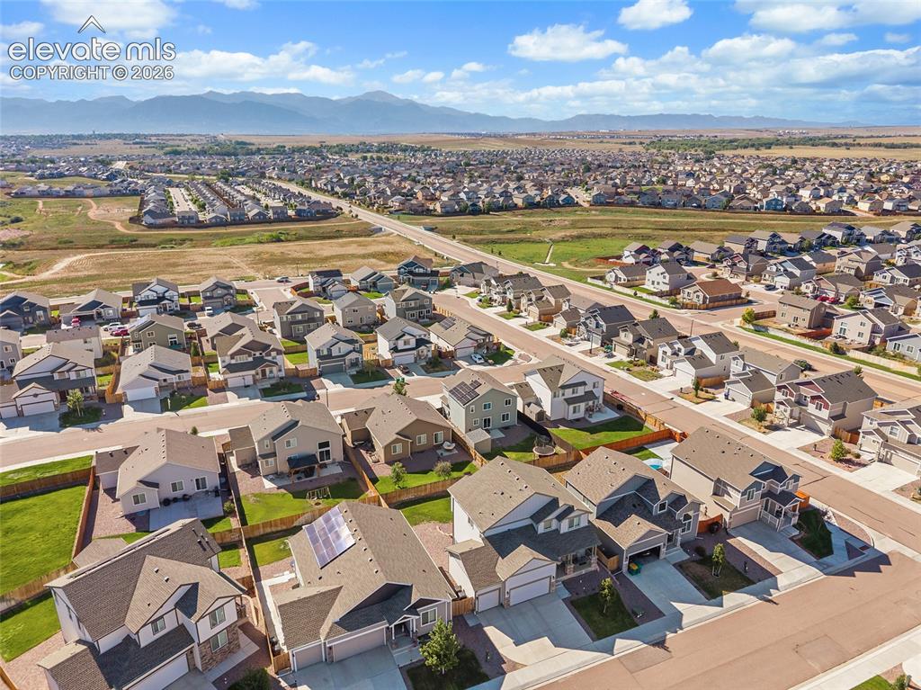 Image 44 of 49: Expansive residential development with a mountain backdrop