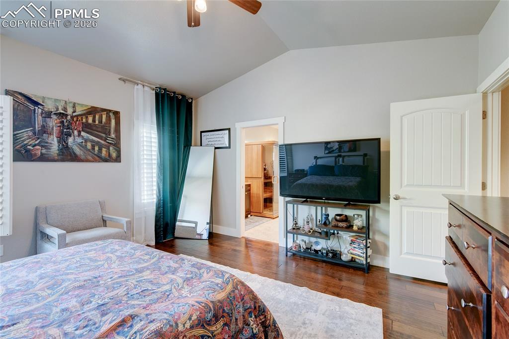 Image 22 of 44: Bedroom featuring lofted ceiling, dark wood finished floors, ceiling fan, a