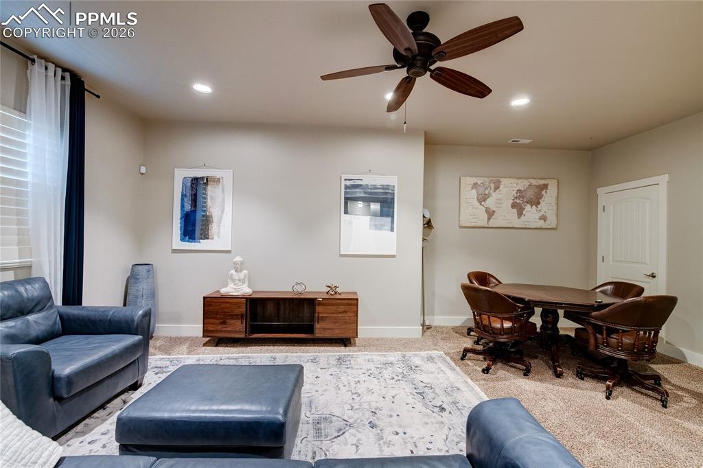Image 29 of 44: Carpeted living area with ceiling fan and recessed lighting