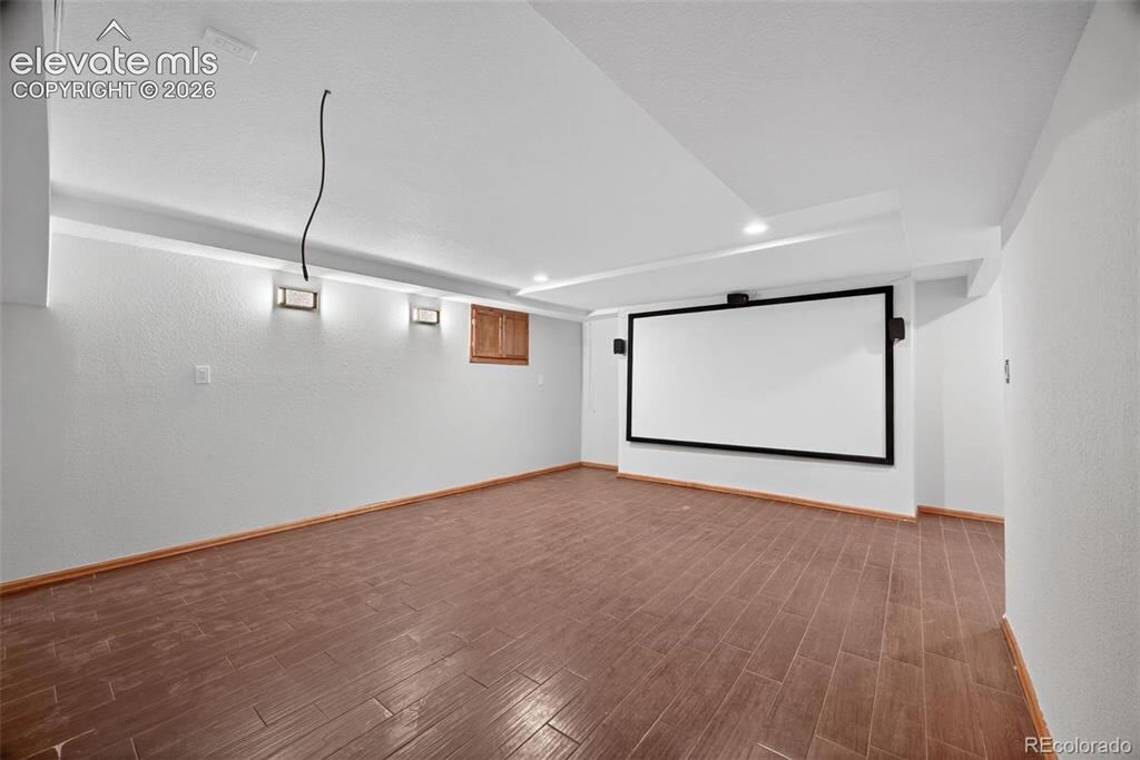 Image 37 of 50: Finished room featuring wood-finish tile flooring, recessed ceiling lightin