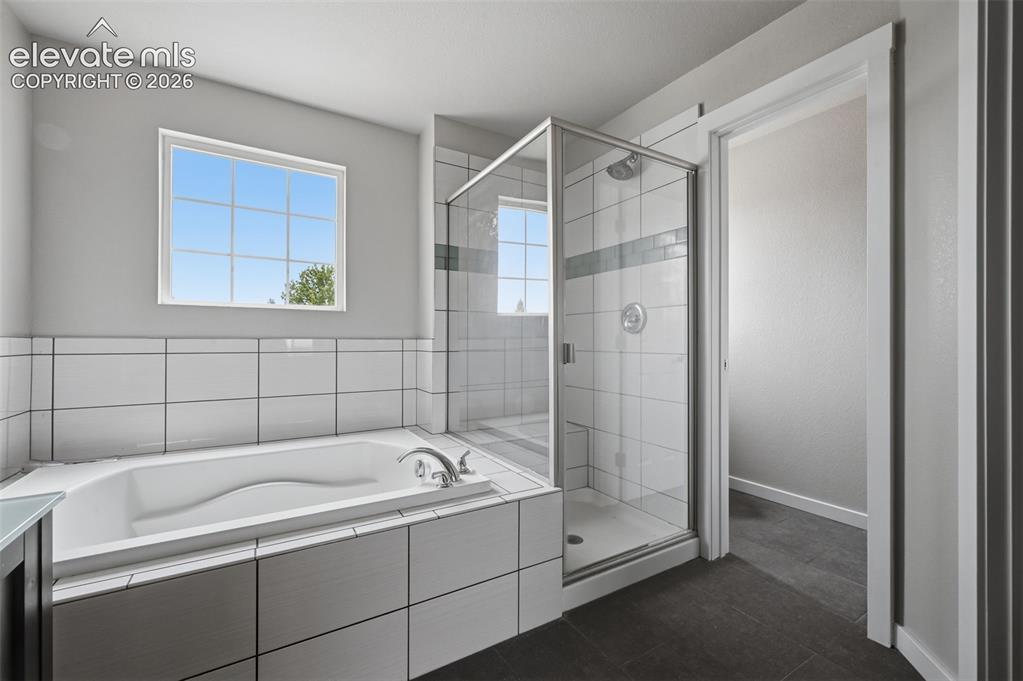 Image 20 of 32: Primary Bath with Tub and Free Standing Shower