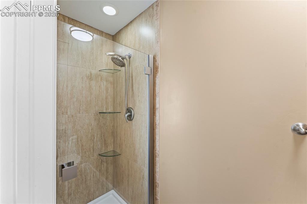 Image 25 of 48: Newly tiled shower in the primary bath