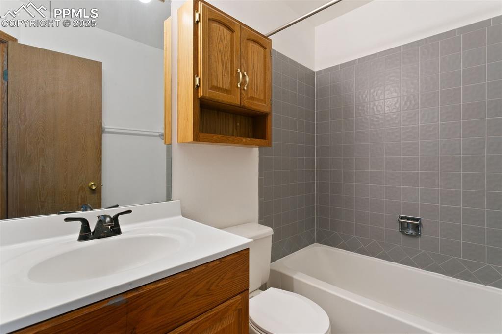 Image 15 of 24: Bathroom with vanity and shower / tub combination