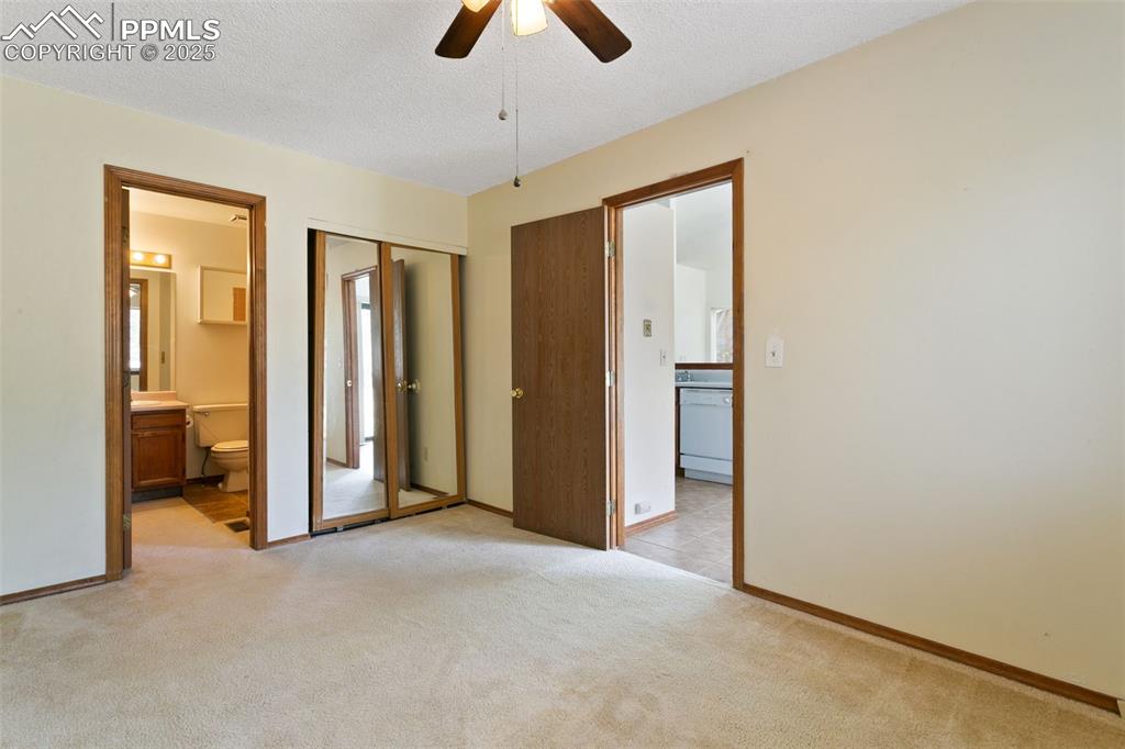 Image 17 of 24: Unfurnished bedroom featuring ensuite bath, a textured ceiling, light color