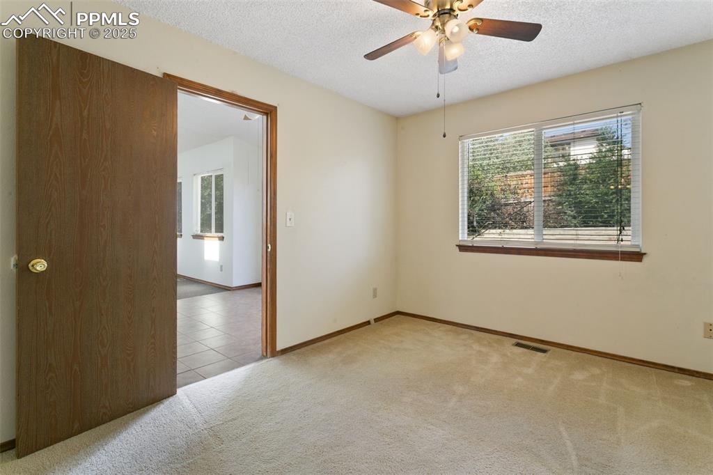 Image 18 of 24: Unfurnished room featuring healthy amount of natural light, a textured ceil
