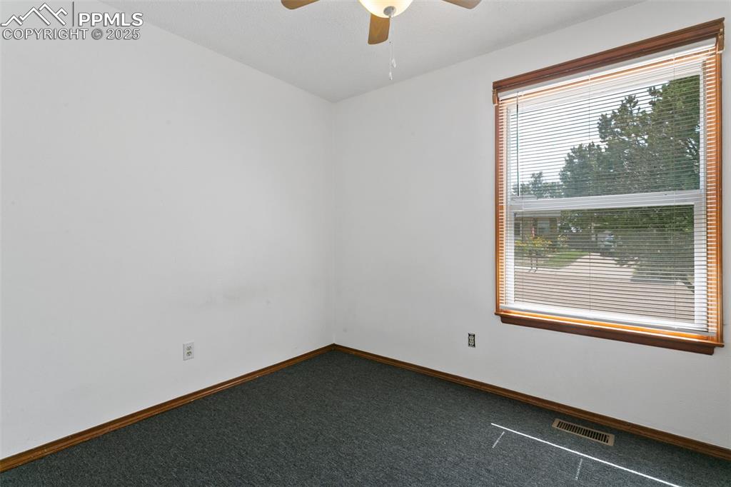 Image 20 of 24: Unfurnished room featuring carpet floors and a ceiling fan