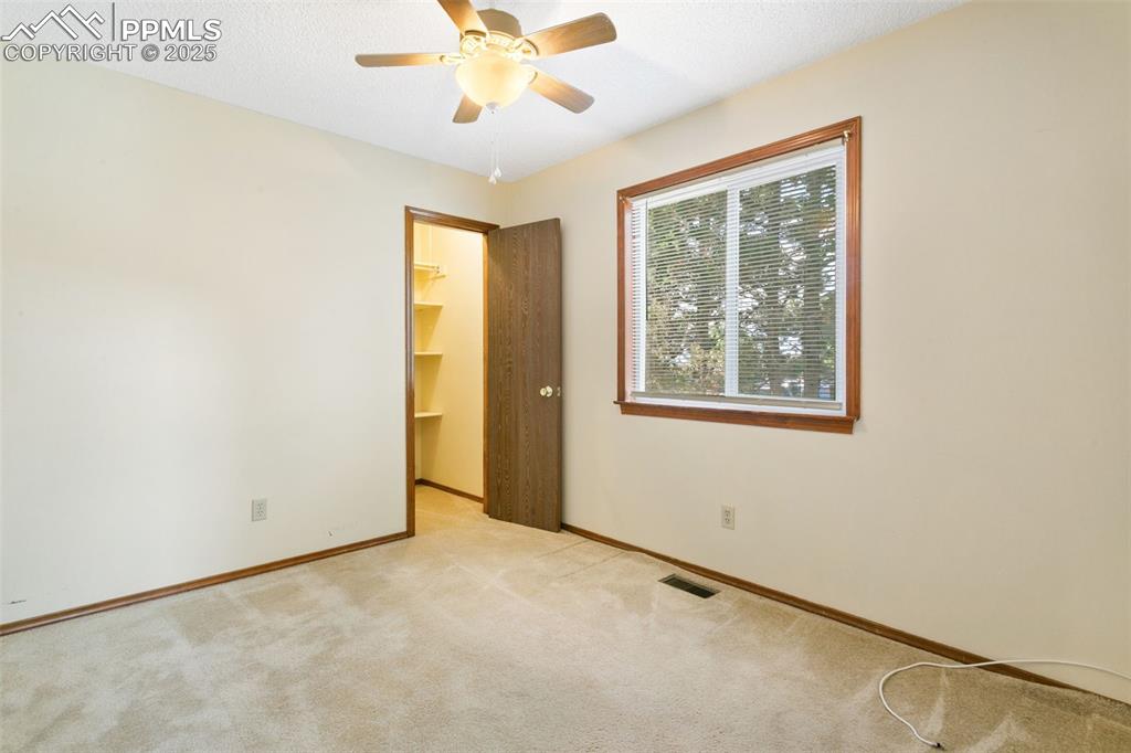 Image 22 of 24: Empty room featuring light colored carpet, a textured ceiling, and a ceilin