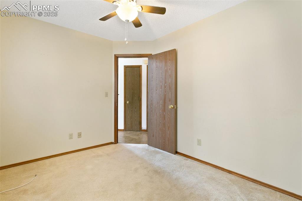 Image 23 of 24: Spare room with carpet flooring, a textured ceiling, and ceiling fan