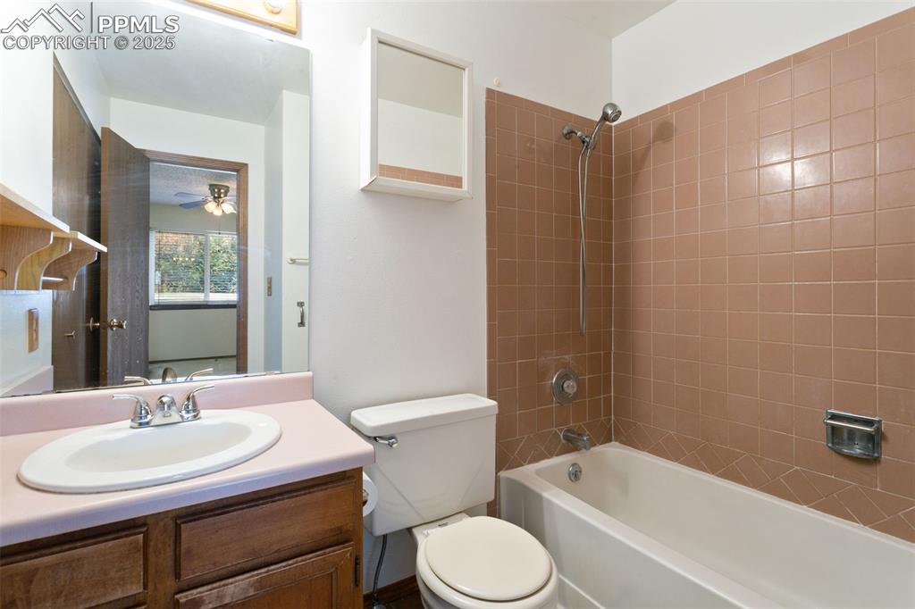 Image 7 of 24: Bathroom with shower / washtub combination and vanity