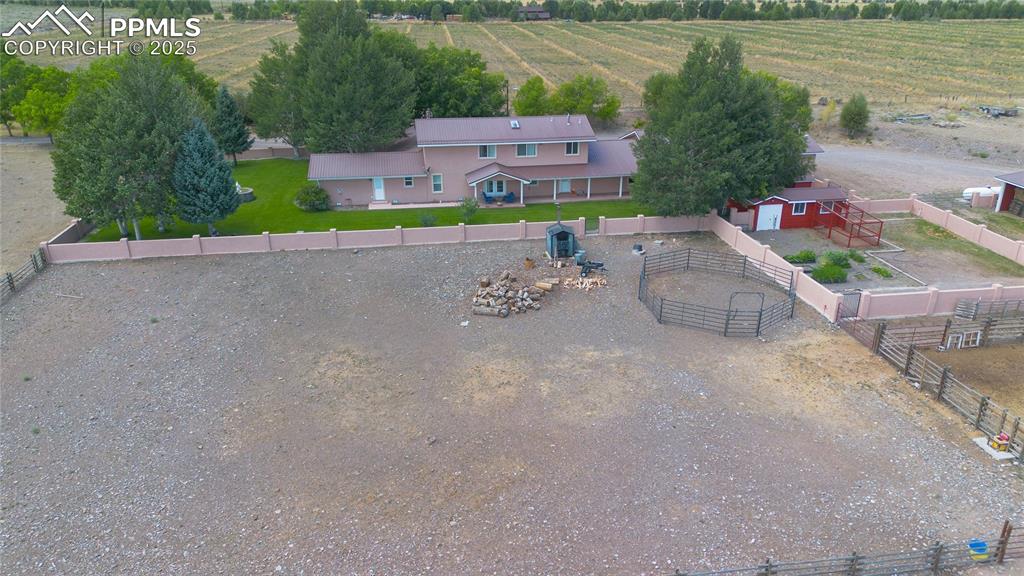 Image 4 of 50: Aerial view of sparsely populated area with rows of crops