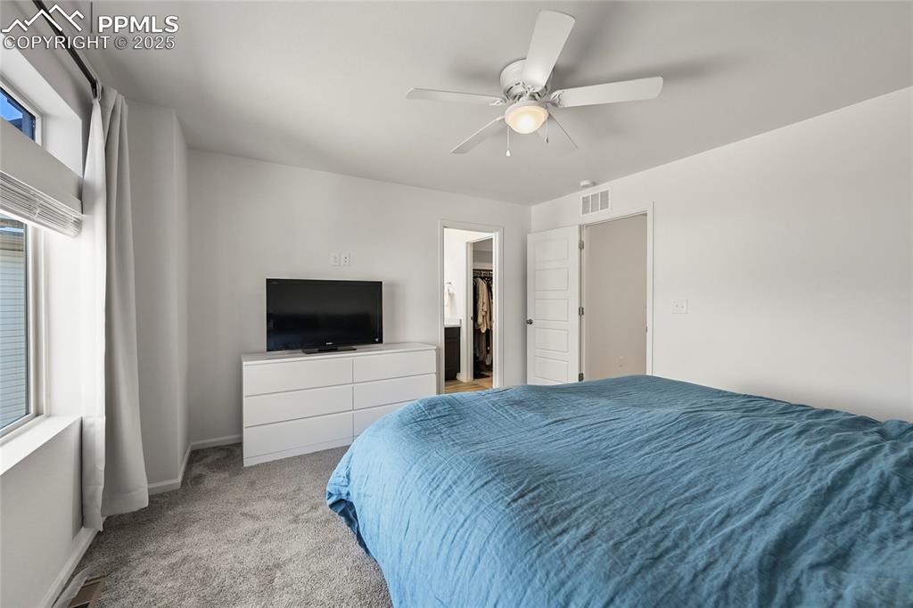 Image 17 of 28: Bedroom featuring carpet flooring, ceiling fan, and a spacious closet