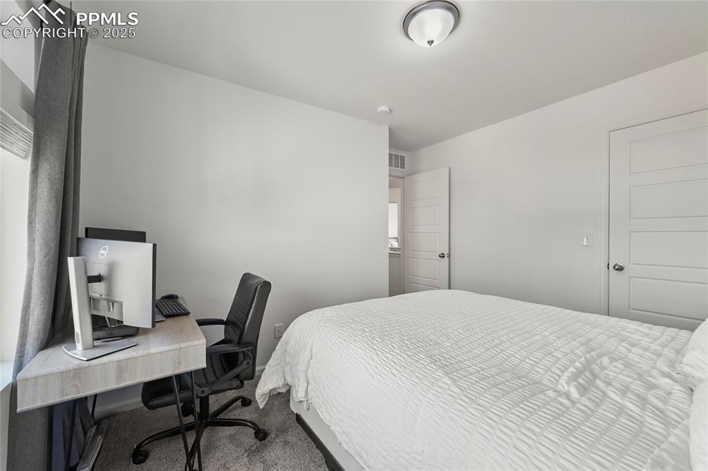 Image 21 of 28: Bedroom featuring carpet and an office area