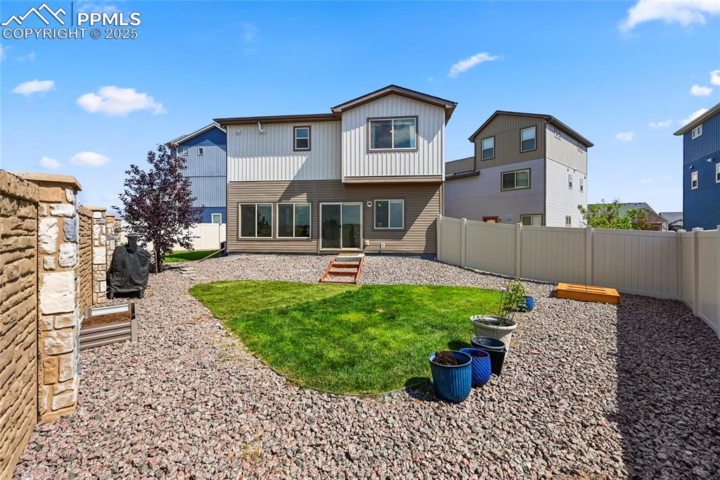Image 26 of 28: Back of property with a patio, a fenced backyard, and entry steps