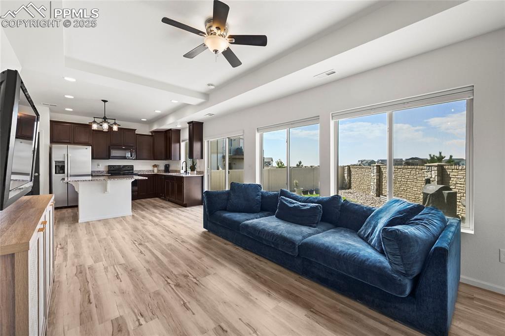 Image 6 of 28: Living room with a ceiling fan, light wood-style flooring, and recessed lig