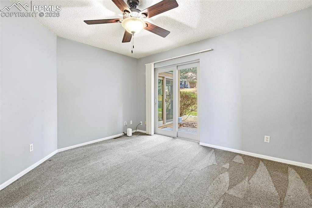 Image 12 of 30: The main-level primary suite offers private patio access...