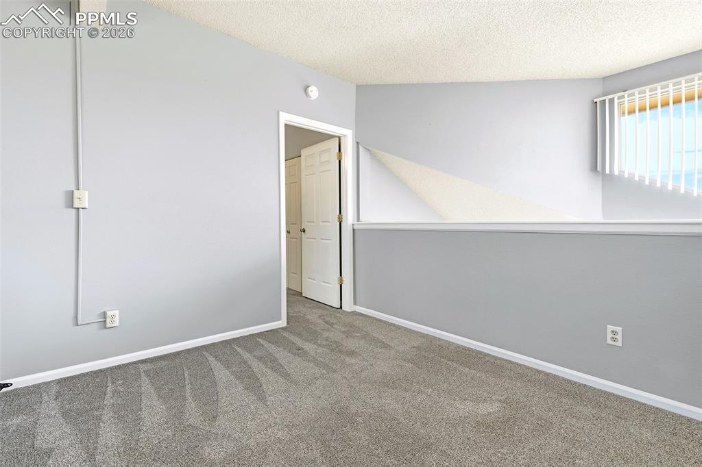 Image 15 of 30: Upstairs, a versatile loft overlooks the living space and kitchen from abov