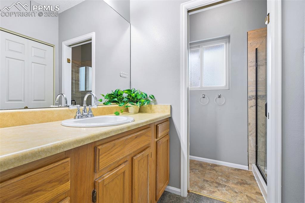 Image 21 of 30: with attached 3/4 bath & plenty of cabinets and counter space.