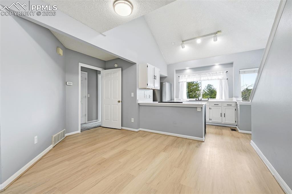 Image 8 of 30: Spacious dining area open to the kitchen and counter bar.