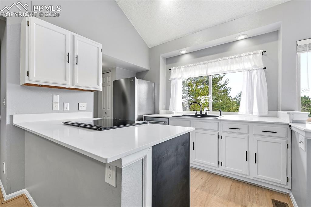 Image 9 of 30: The galley kitchen is both functional and stylish, offering quartz countert