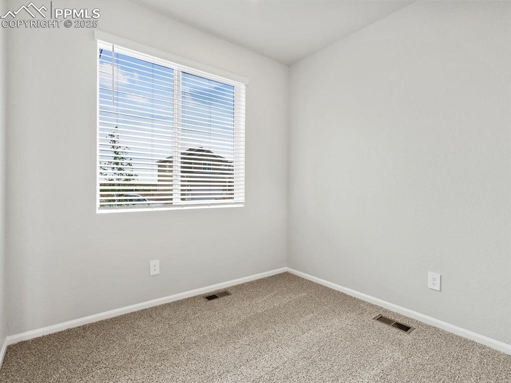 Image 10 of 28: Carpeted empty room with baseboards