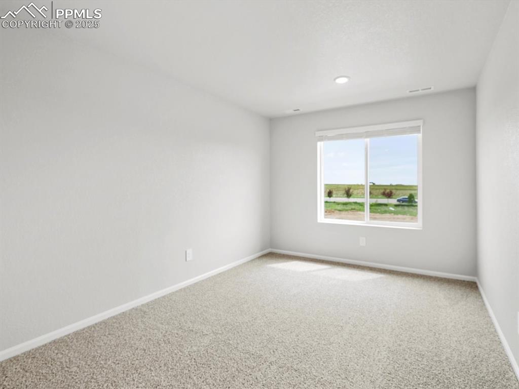Image 13 of 28: Spare room featuring carpet floors and baseboards