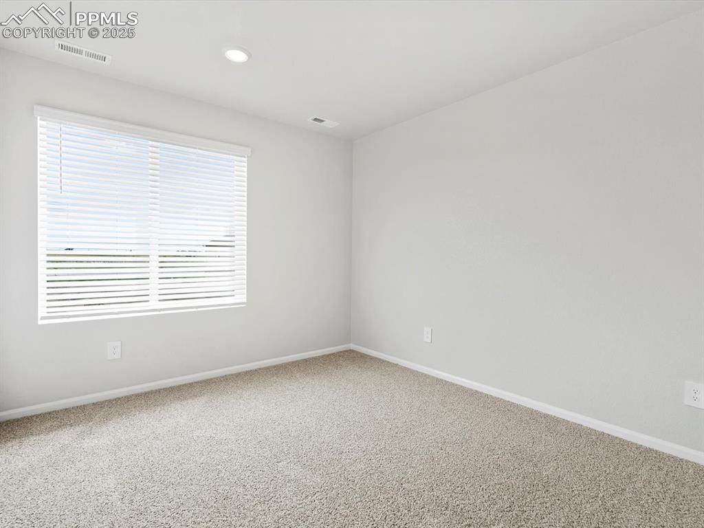 Image 17 of 28: Carpeted spare room featuring baseboards and recessed lighting