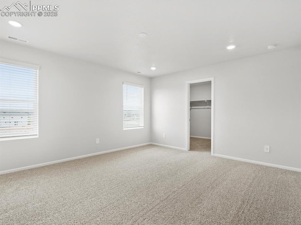 Image 19 of 28: Unfurnished bedroom with recessed lighting, light carpet, and a spacious cl