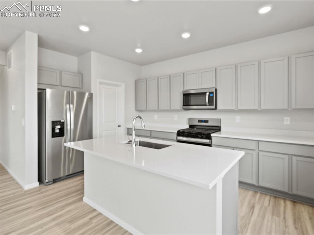 Image 2 of 28: Kitchen with stainless steel appliances, recessed lighting, gray cabinetry,
