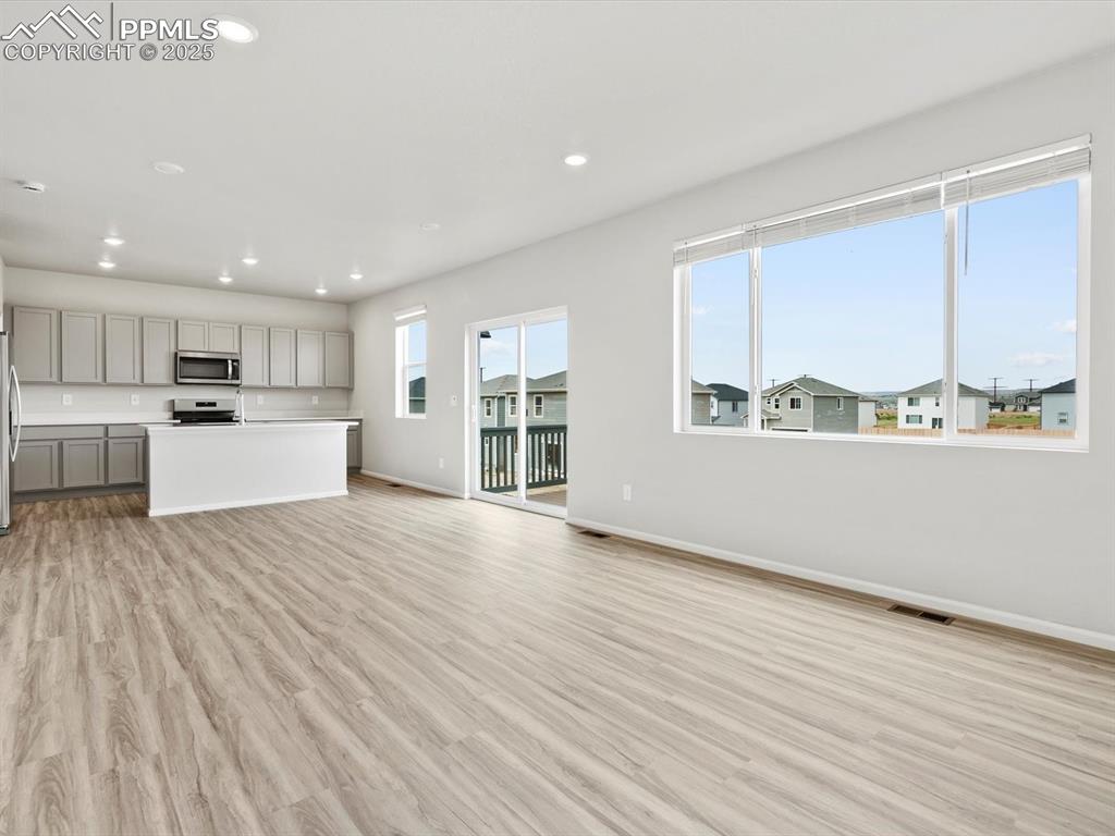 Image 5 of 28: Unfurnished living room featuring recessed lighting and light wood finished