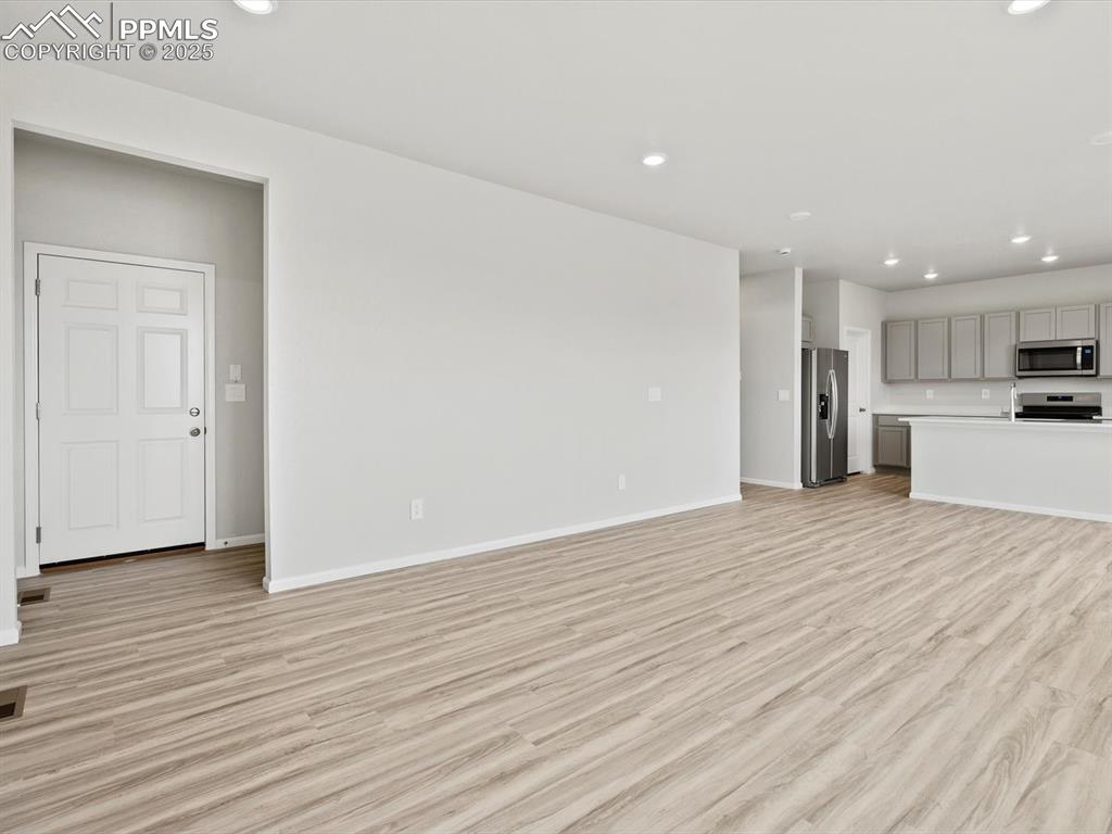 Image 6 of 28: Unfurnished living room with recessed lighting and light wood-type flooring