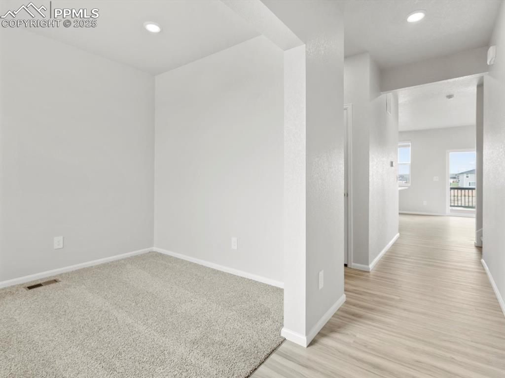 Image 8 of 28: Empty room featuring recessed lighting, light carpet, and light wood-type f