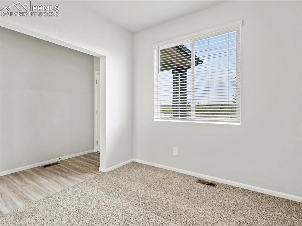 Image 9 of 28: Empty room with carpet floors and baseboards