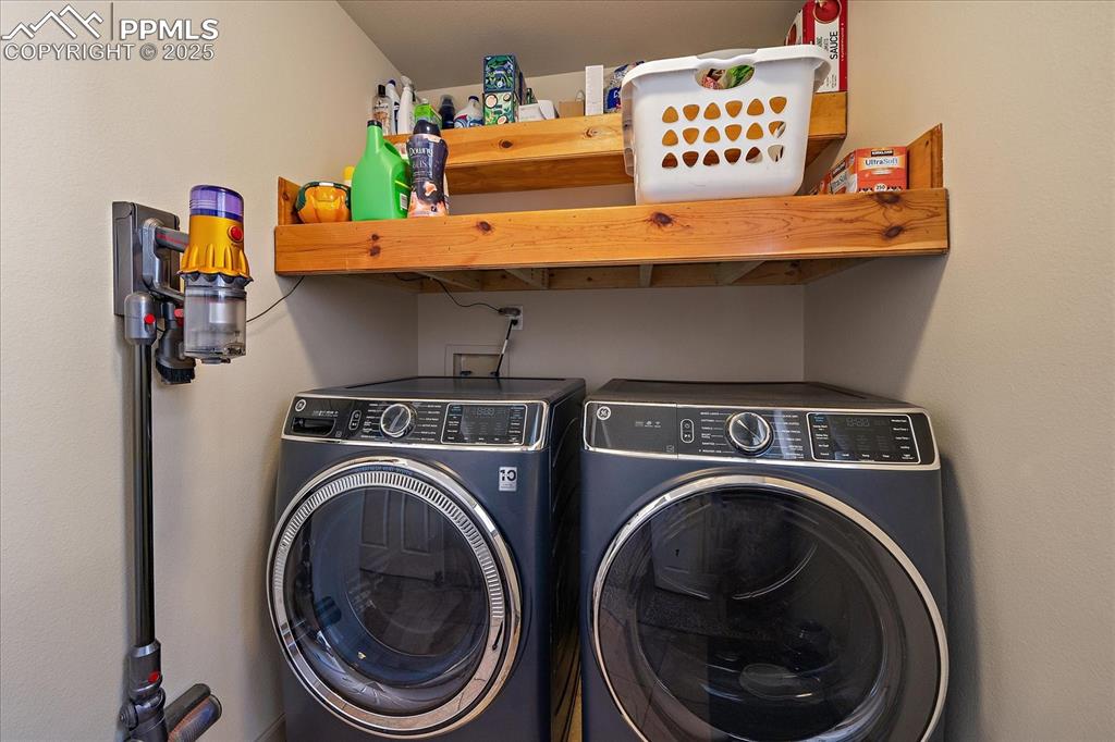 Image 22 of 47: Laundry room with washer and clothes dryer