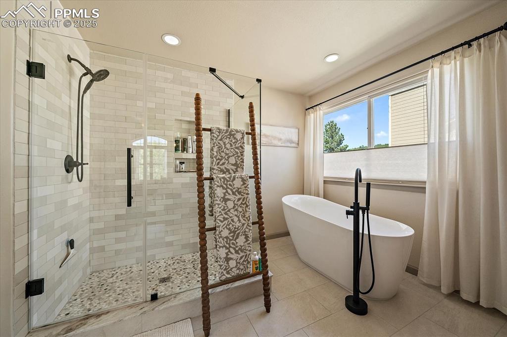Image 27 of 47: Full bathroom with a shower stall, a freestanding bath, recessed lighting, 