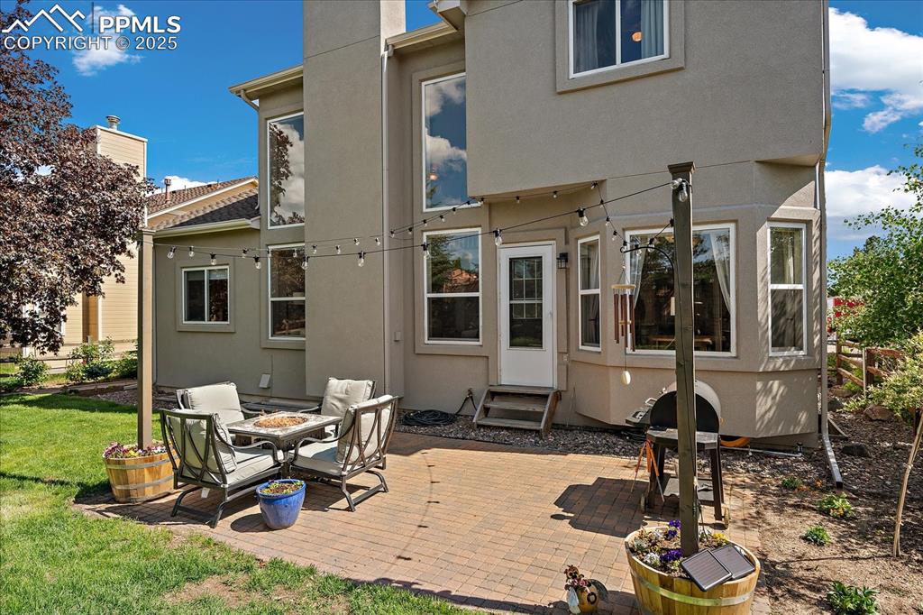 Image 4 of 47: Rear view of property featuring entry steps, stucco siding, a patio area, a