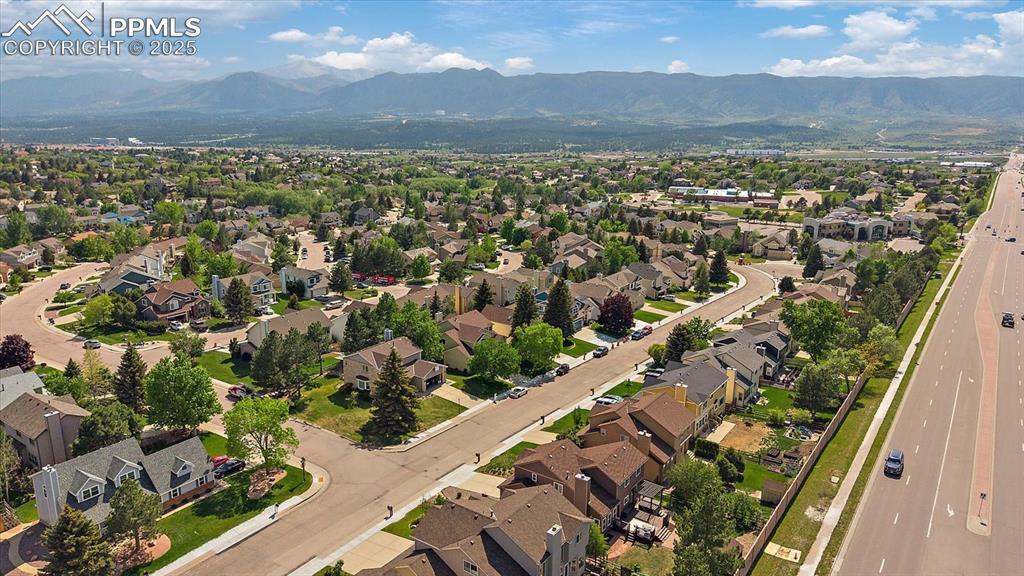 Image 47 of 47: Aerial view of property and surrounding area with a mountainous background 