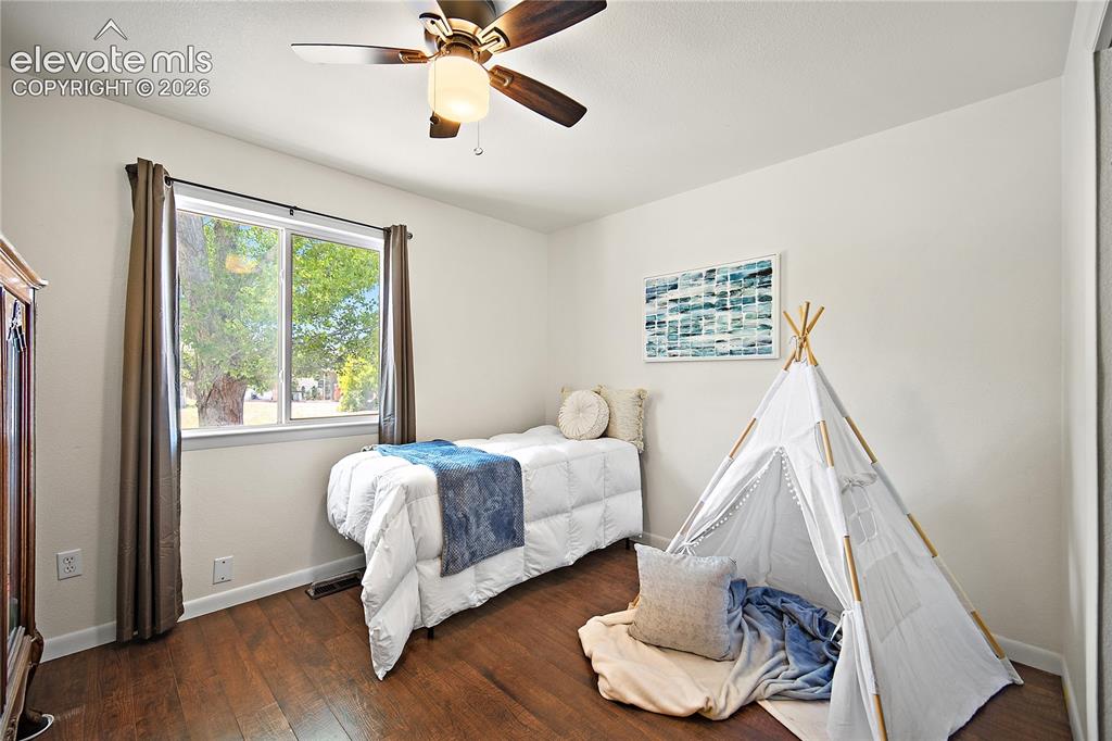 Image 14 of 29: Bedroom featuring wood-finish flooring, a ceiling fan with integrated light