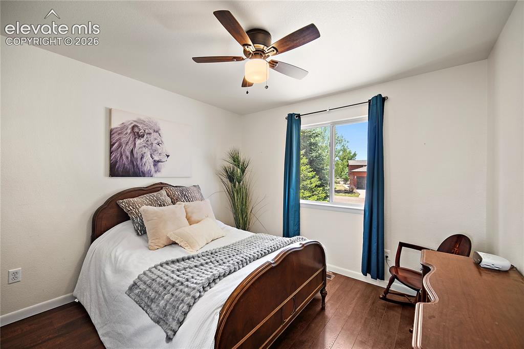 Image 15 of 29: Room featuring wood-finish flooring, a window with exterior views, and a ce