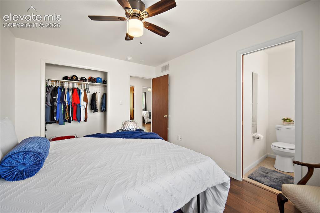 Image 18 of 29: Dedicated laundry area featuring light wood-finish cabinetry and a paneled