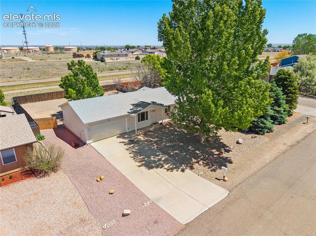 Image 25 of 29: Expansive property featuring a detached garage, mature trees, gravel landsc