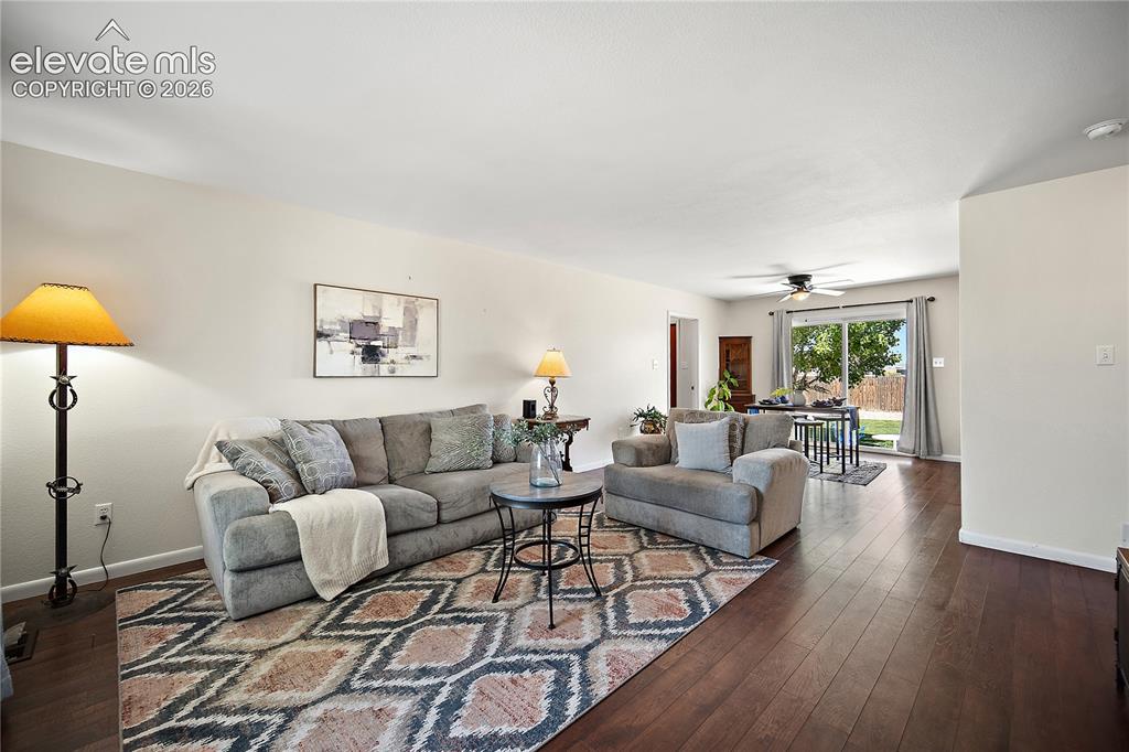 Image 3 of 29: Spacious interior featuring wood-finish flooring, light-toned walls, and a