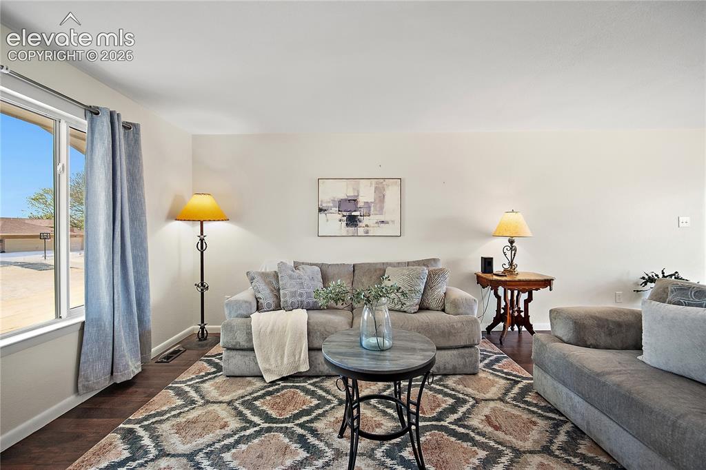 Image 4 of 29: Bedroom with wood-finish flooring, a ceiling fan with integrated lighting,