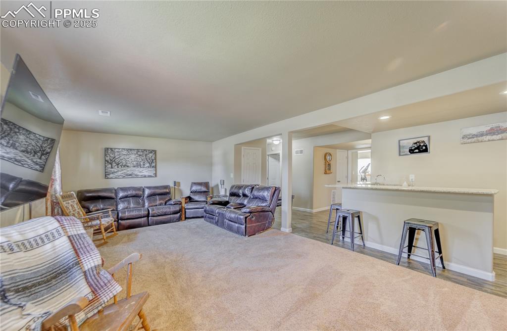 Image 23 of 25: Wet bar sets off the family room