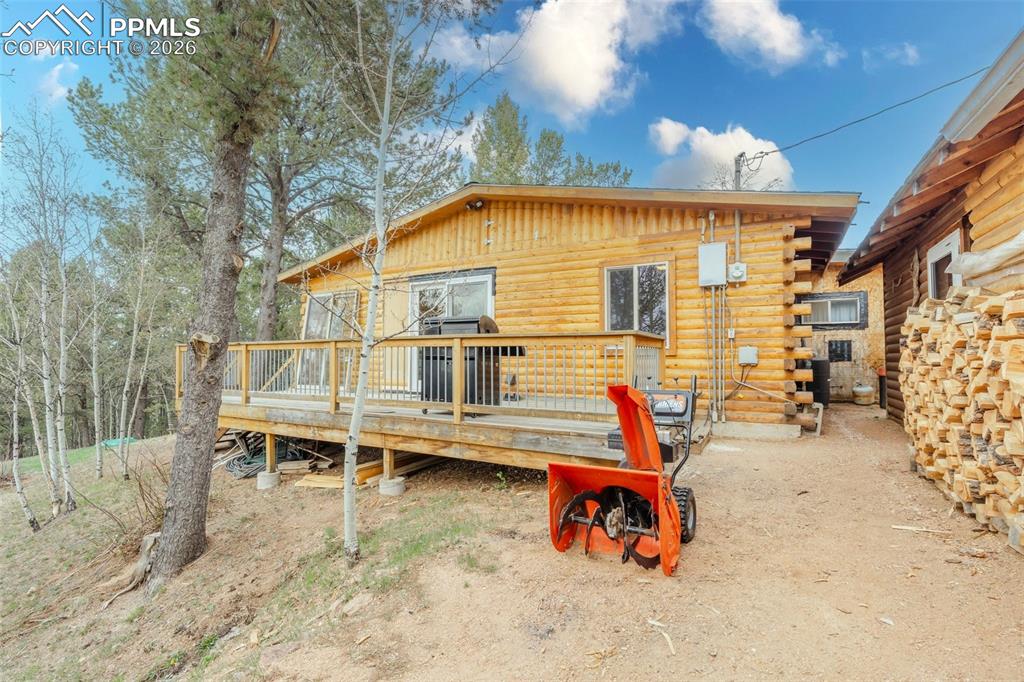 Image 28 of 41: Wood-sided exterior featuring a spacious wood deck